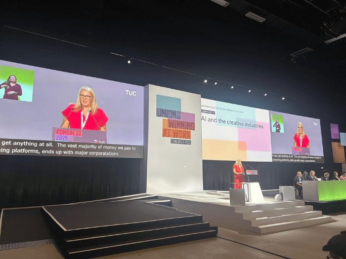 MU General Secretary Naomi Pohl on stage at TUC 2025, addressing delegates about the motion on AI and the creative industries.