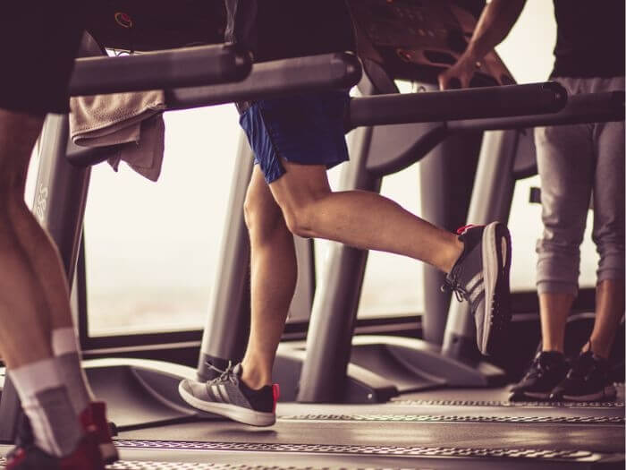 Close up of legs running on a treadmill.
