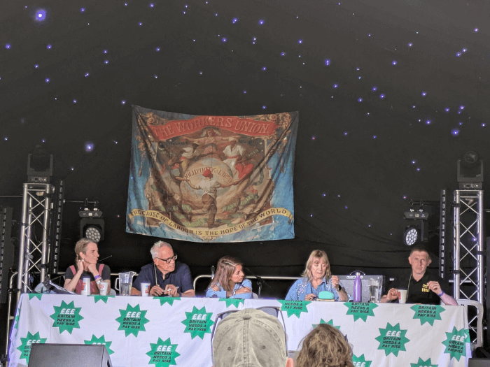 Andy Warnock speaking on a panel on the main stage at Tolpuddle./