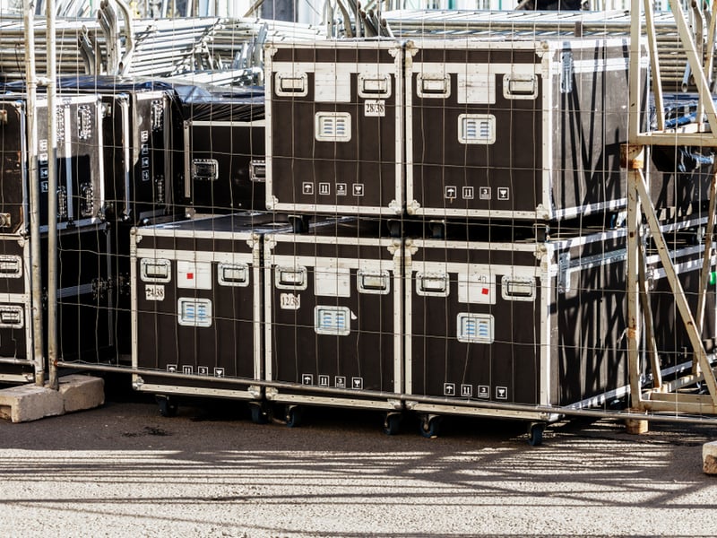 A number of touring crates stand on tarmac