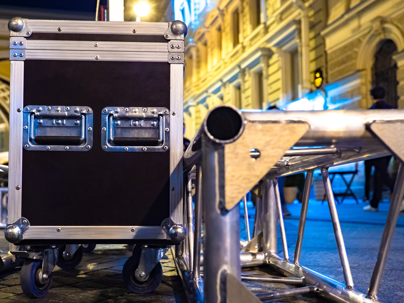 Photograph of some touring equipment, a box for packing and parts of a stage frame.