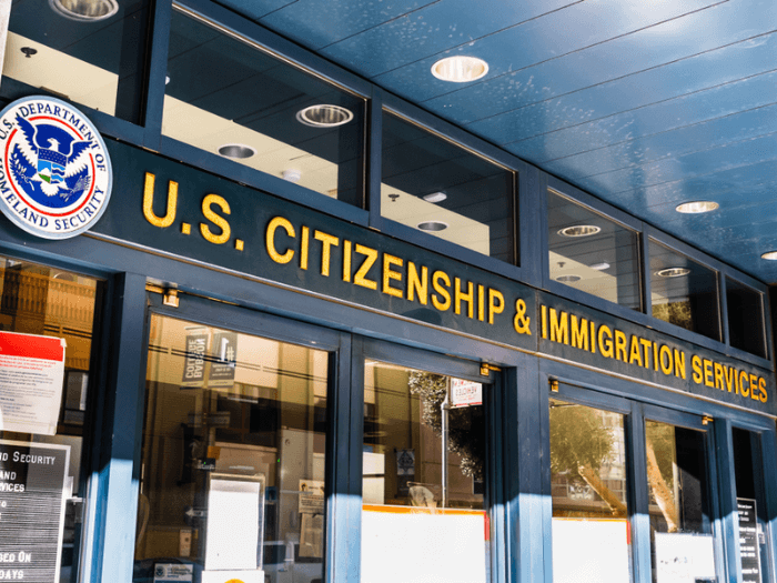 The office front of a building with the name US Citizenship and Immigration Services.