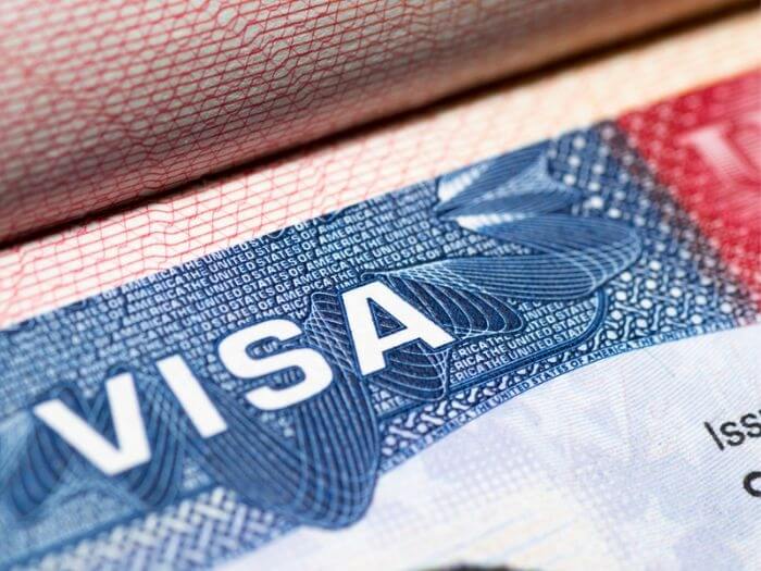 Close up of a Visa stamp on a passport.