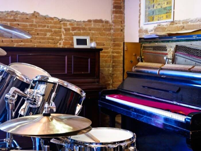 Drum kit and piano in a music classroom.