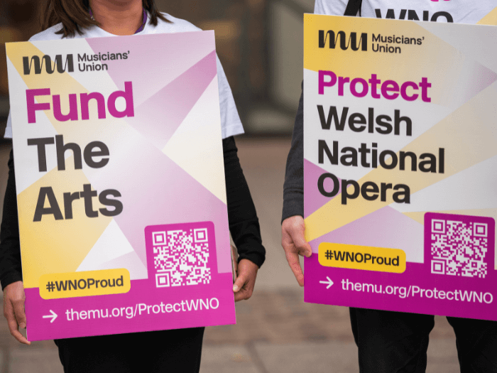 WNO musicians holding up placards to support the Protect WNO campaign.