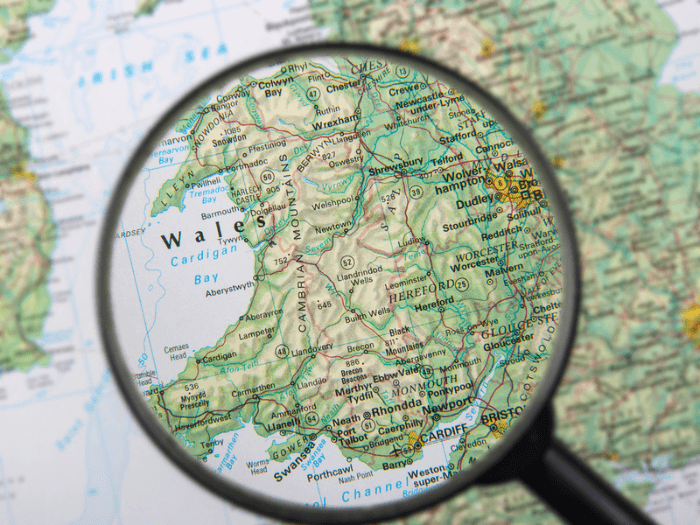 Wales on the map under a magnifier.