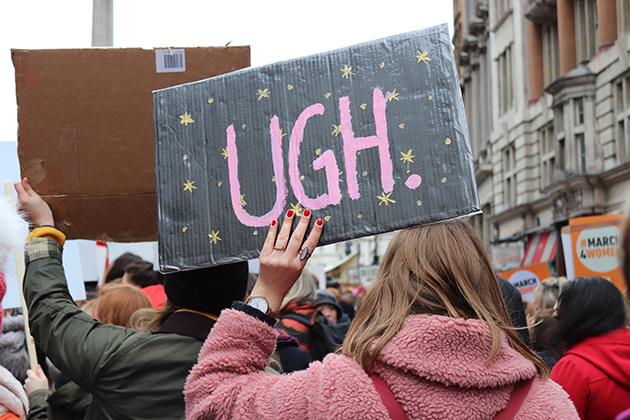 Photo from the Women's march in 2018, person holding large sign reading 