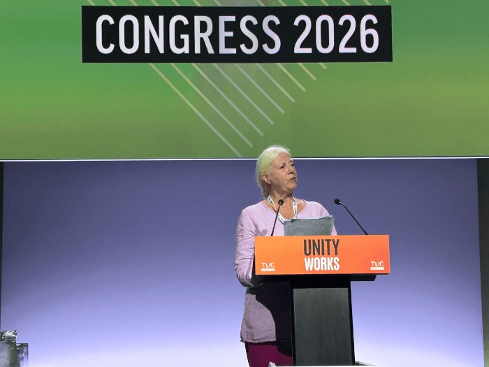 Xenia Horne standing at a lectern at TUC Congress.