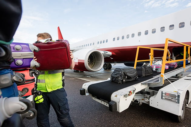 Photo of baggage being loaded into a place