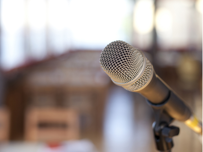 Microphone in front of a blurred cafe setting