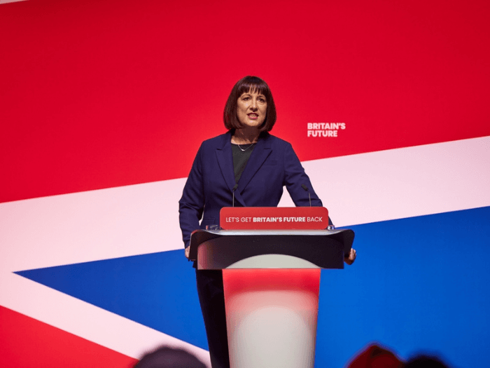 Chancellor Rachel Reeves standing at a podium.