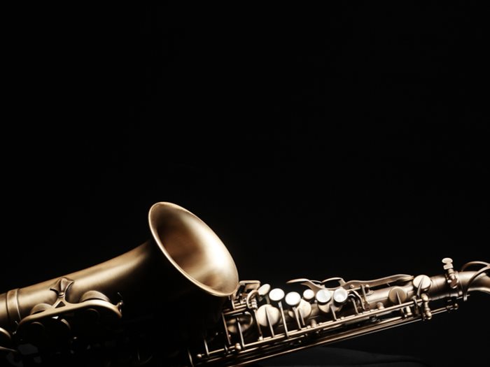 Saxophone music instrument closeup on black