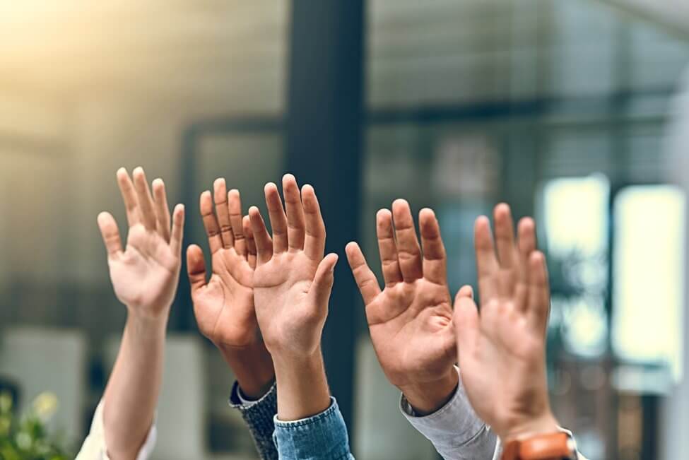 Group of hands voting.